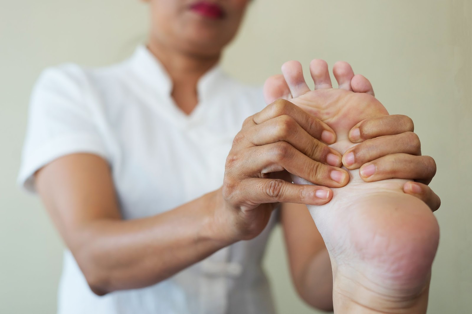Close-up of a therapist providing a foot massage to address foot problems