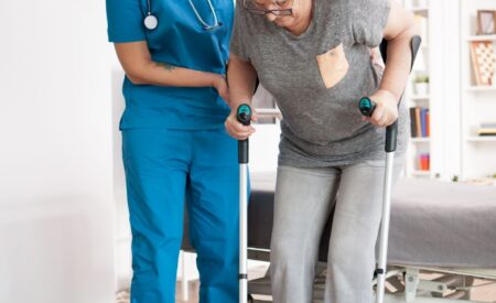 A woman podiatrist helping an elderly person with foot pain issues