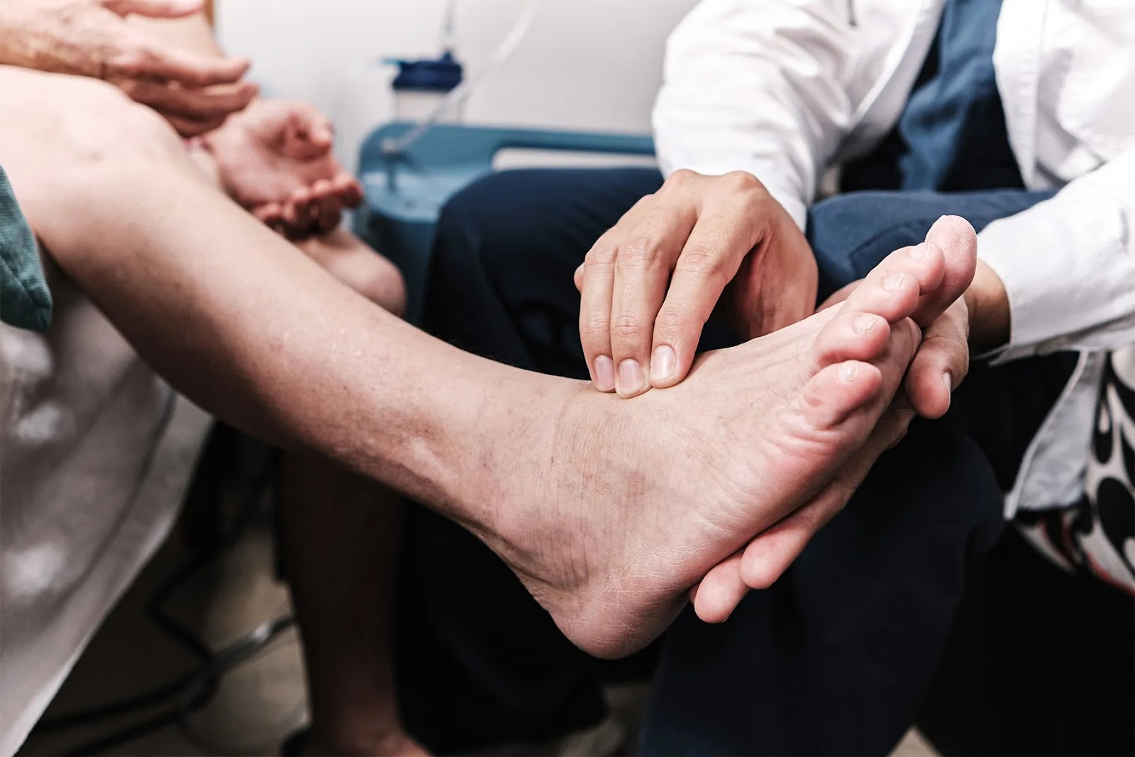 Healthcare professional examining a patient's foot, focused on peripheral neuropathy foot care and managing foot numbness