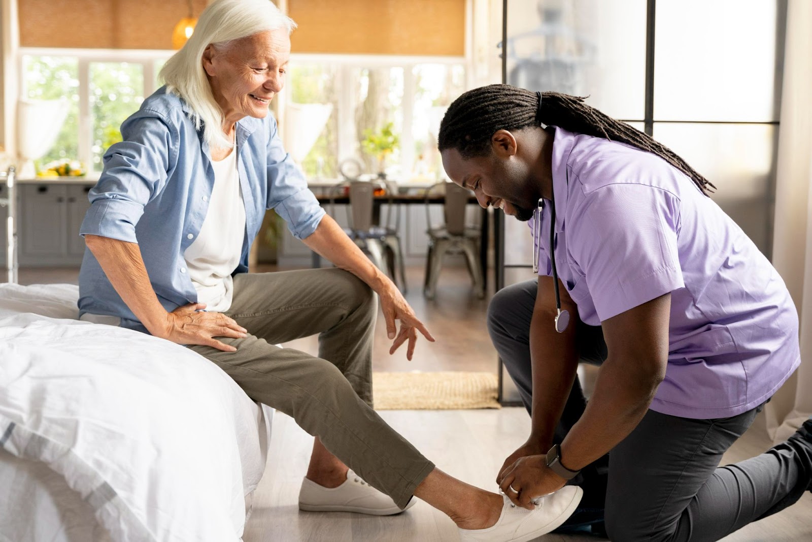 Doctor assisting senior with supportive footwear, part of elderly foot assessments for falls prevention in aged care
