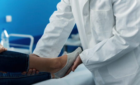 Healthcare professional performing elderly foot assessments to support falls prevention in aged care
